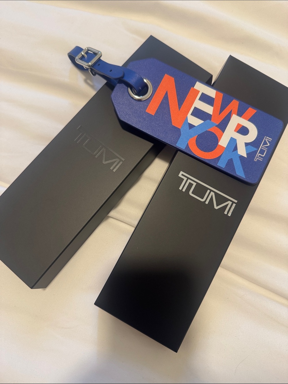 Tumi Blue NEW YORK Graphic Luggage Tag with Orange & Light Blue Lettering